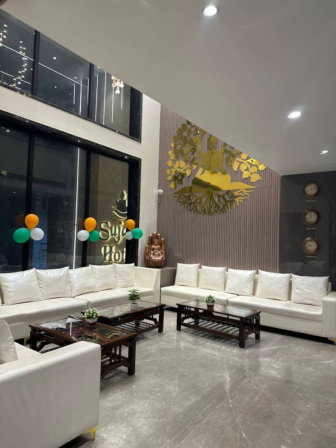 White lobby with Sujata Hotel signage and elegant reception area