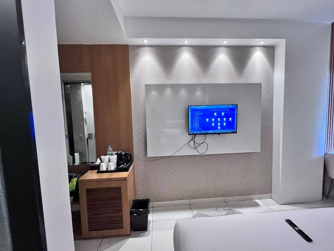 Hotel room with modern TV wall unit and premium furnishings